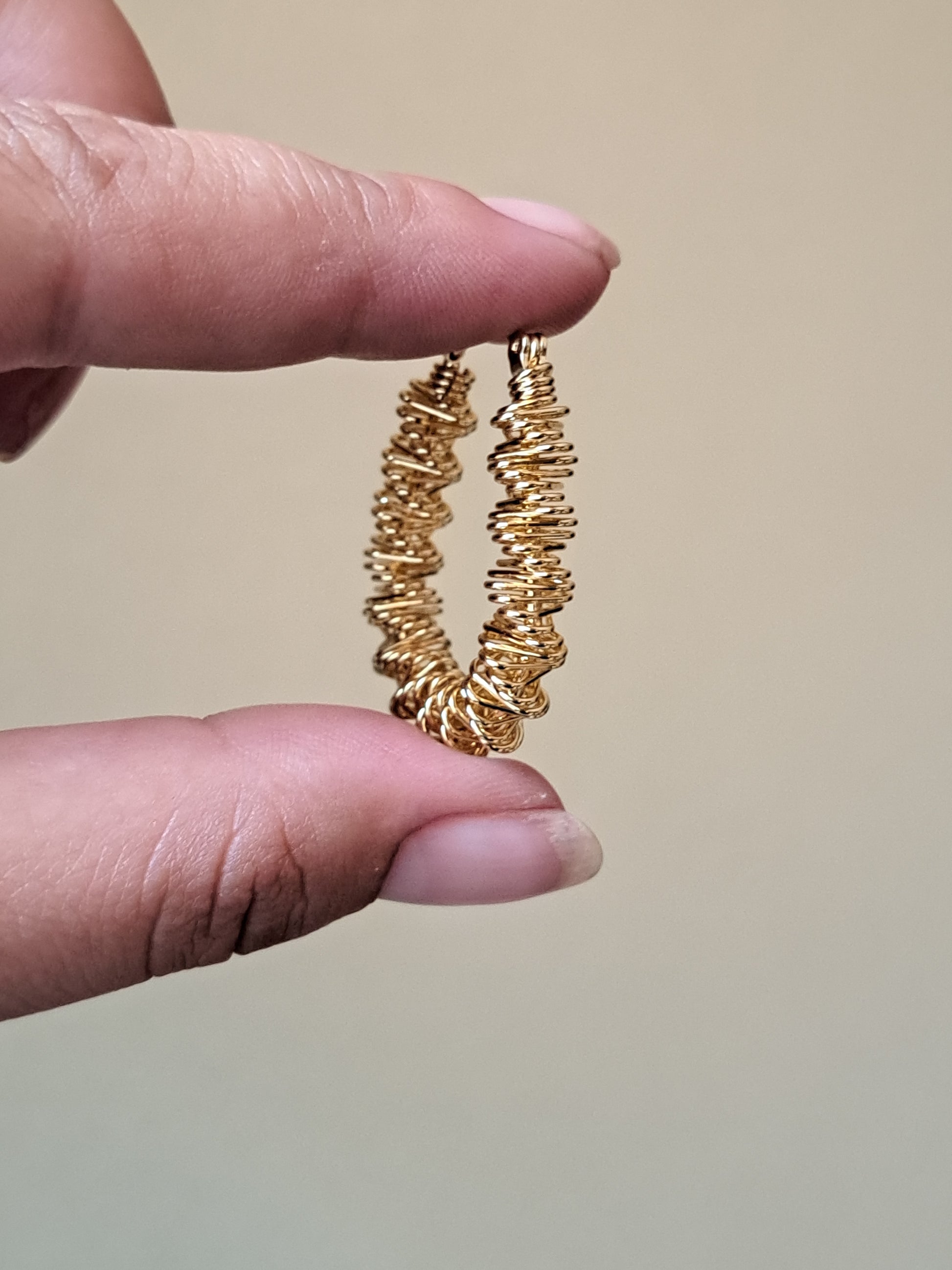 Goudkleurige stainless steel oorbellen. Gedraaid.